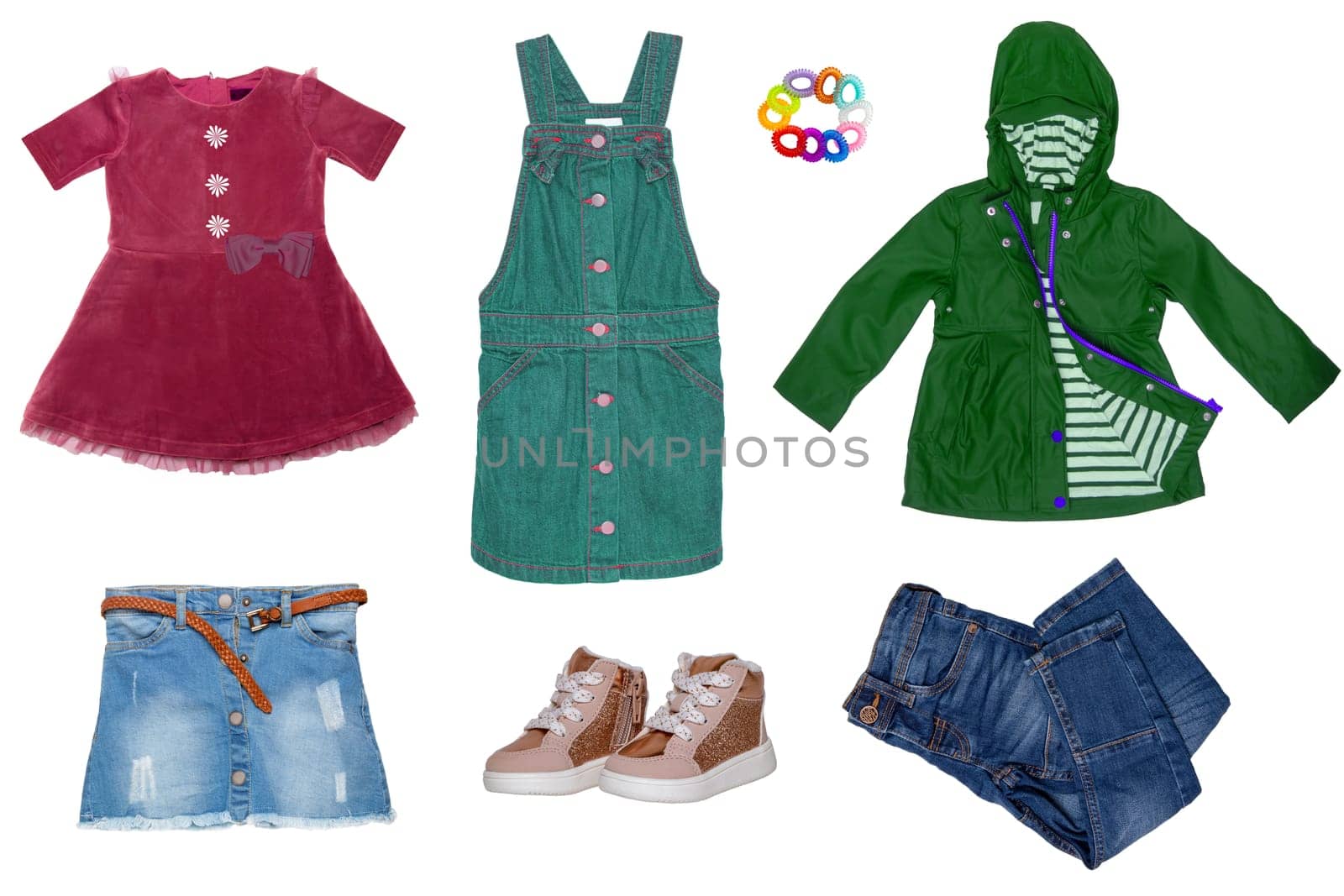 Collage set of little girl summer clothes isolated on a white background. The collection of jeans skirt and pants, short summer skirt, a dress, shoes and a rain jacket. Little girl fashion.