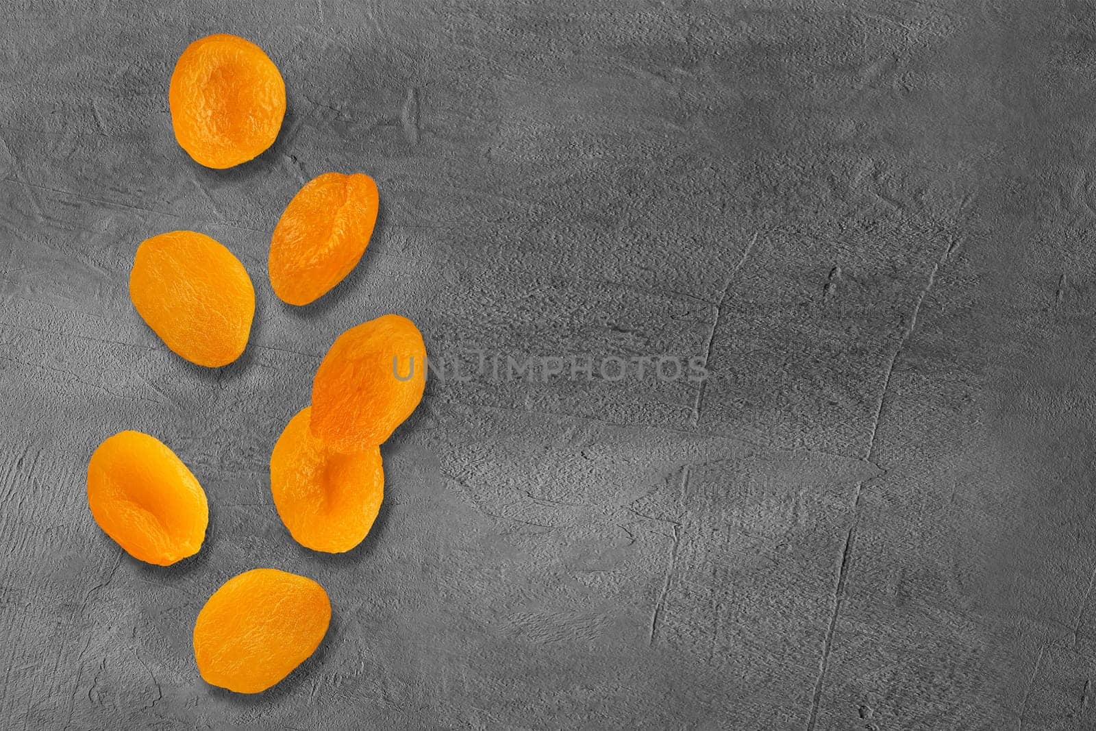 Flying slices dried apricot fruits on creative trendy background. Food levitation concept. Flat lay with copy space.