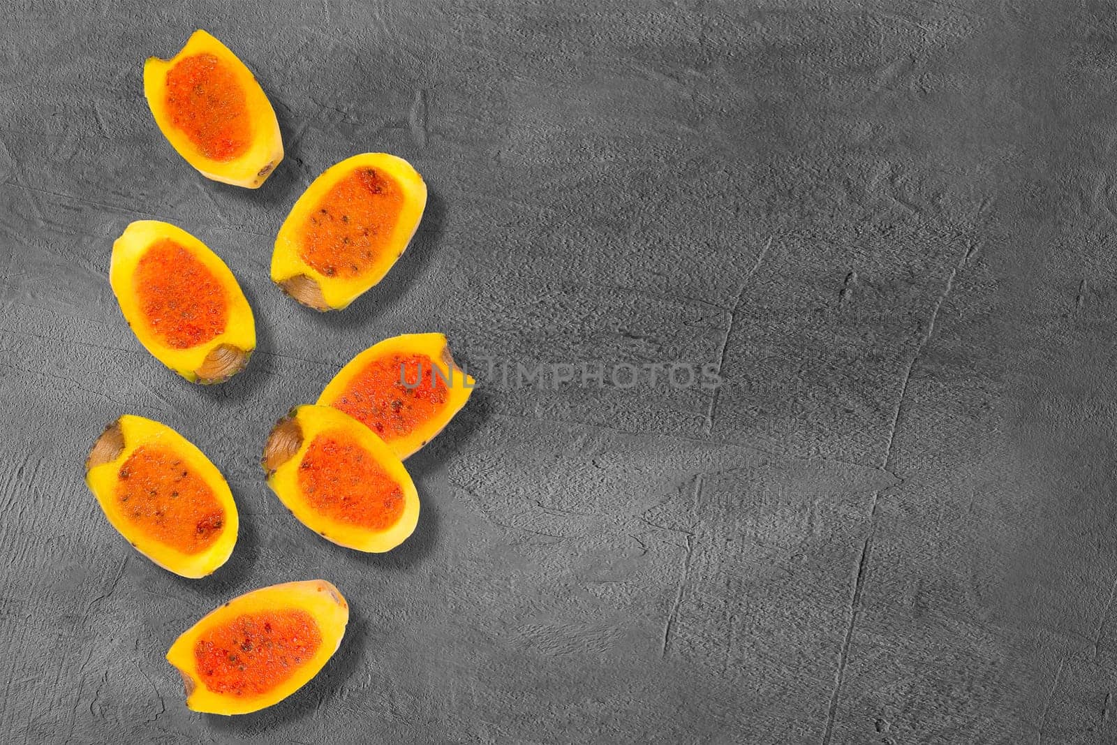 Flying yellow cut in half prickly pear cactus fruits on creative trendy background. Food levitation concept. Flat lay with copy space.