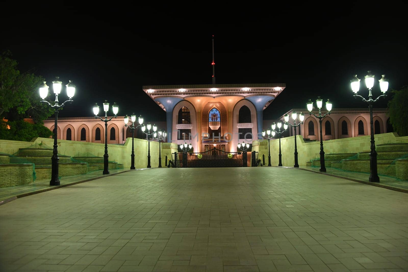 The historical landmark of the Sultan's Palace,also called the Flag Palace,in the of the old town of Muscat at night and lanterns was built in the Anglo-Indian style.