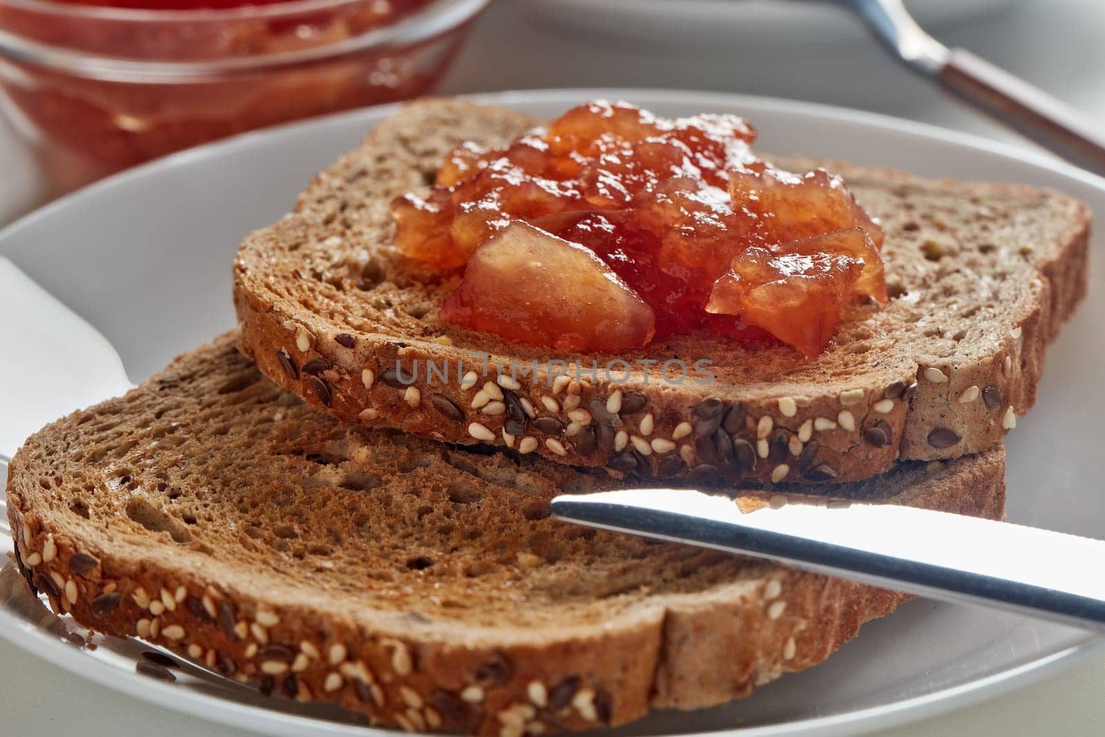 Breakfast. Still life from appetizing  toasts with apple jam and cup of coffee on white background. Selective focus on toast with jam.