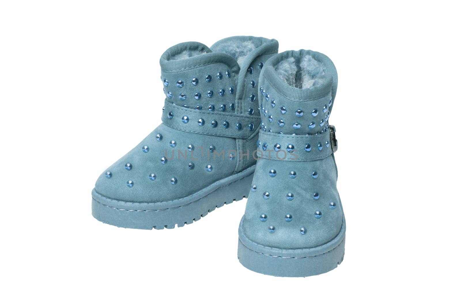 Childrens winter boots. Close-up of a pair elegant blue suede leather winter boots and lined with blue fur. Girls winter shoe fashion new trends isolated on a white background. Macro photograph.