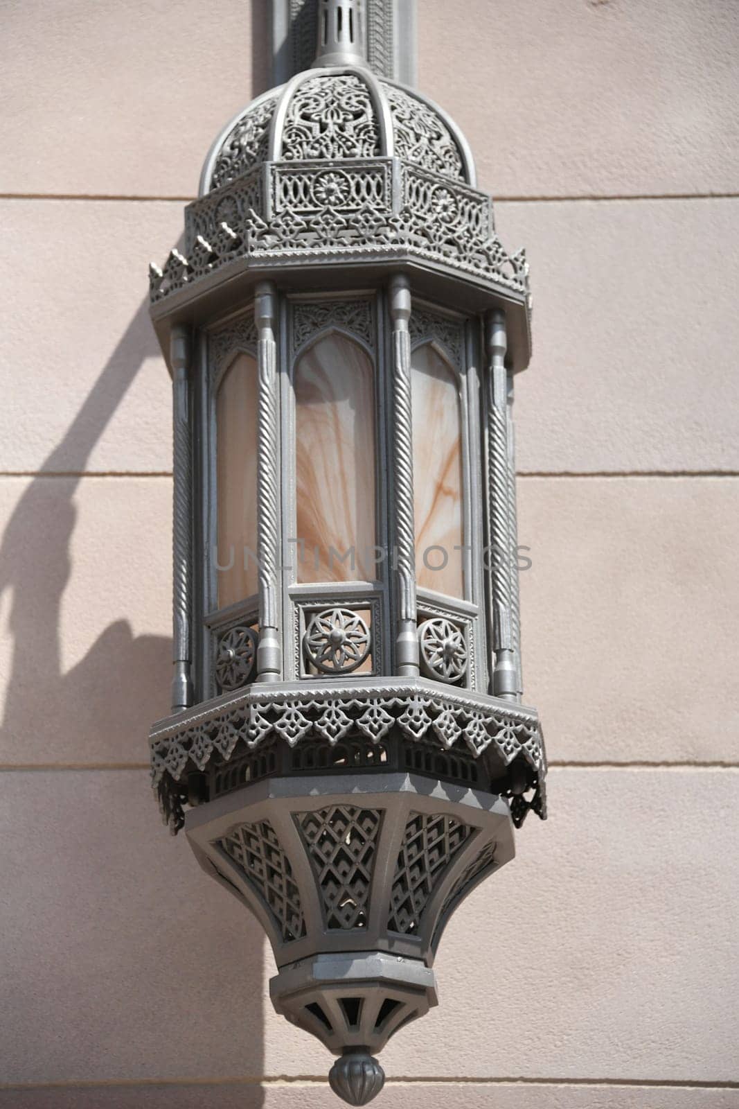 An antique metal street lamp in the Ottoman,oriental style in the city of Muscat in Oman at the Sultan Qaboos Grand Mosque.