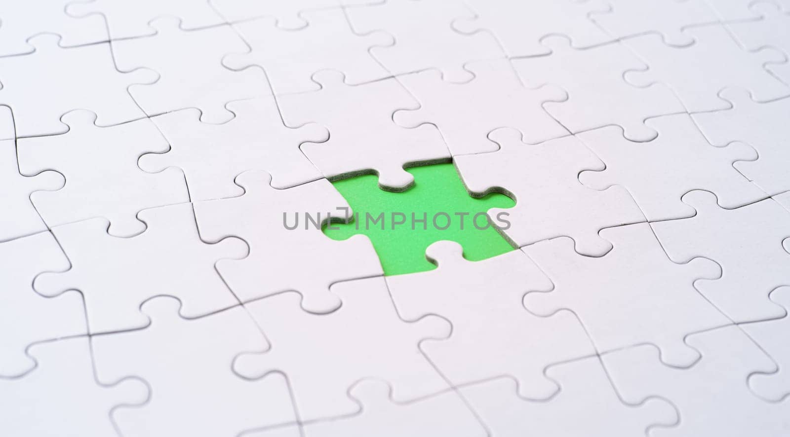 Empty white jigsaw puzzle with missing piece