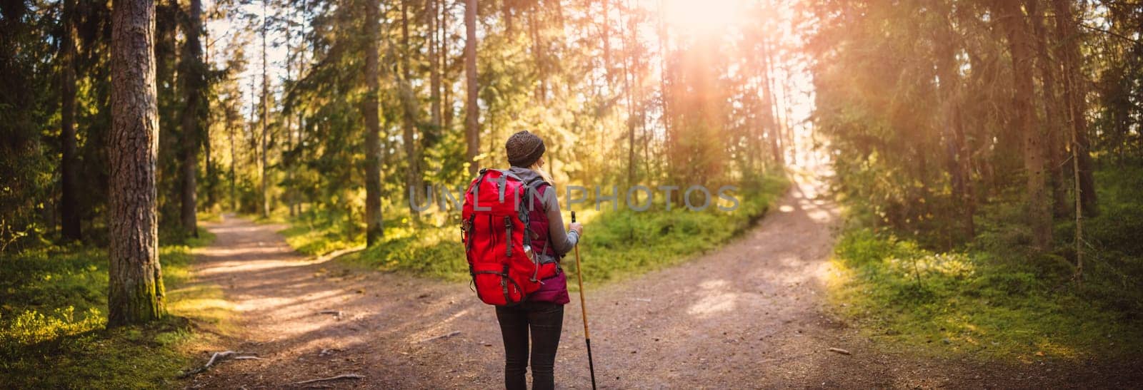 Woman hiking and going camping in nature. Concept of choosing of a right path at the wildlife area.