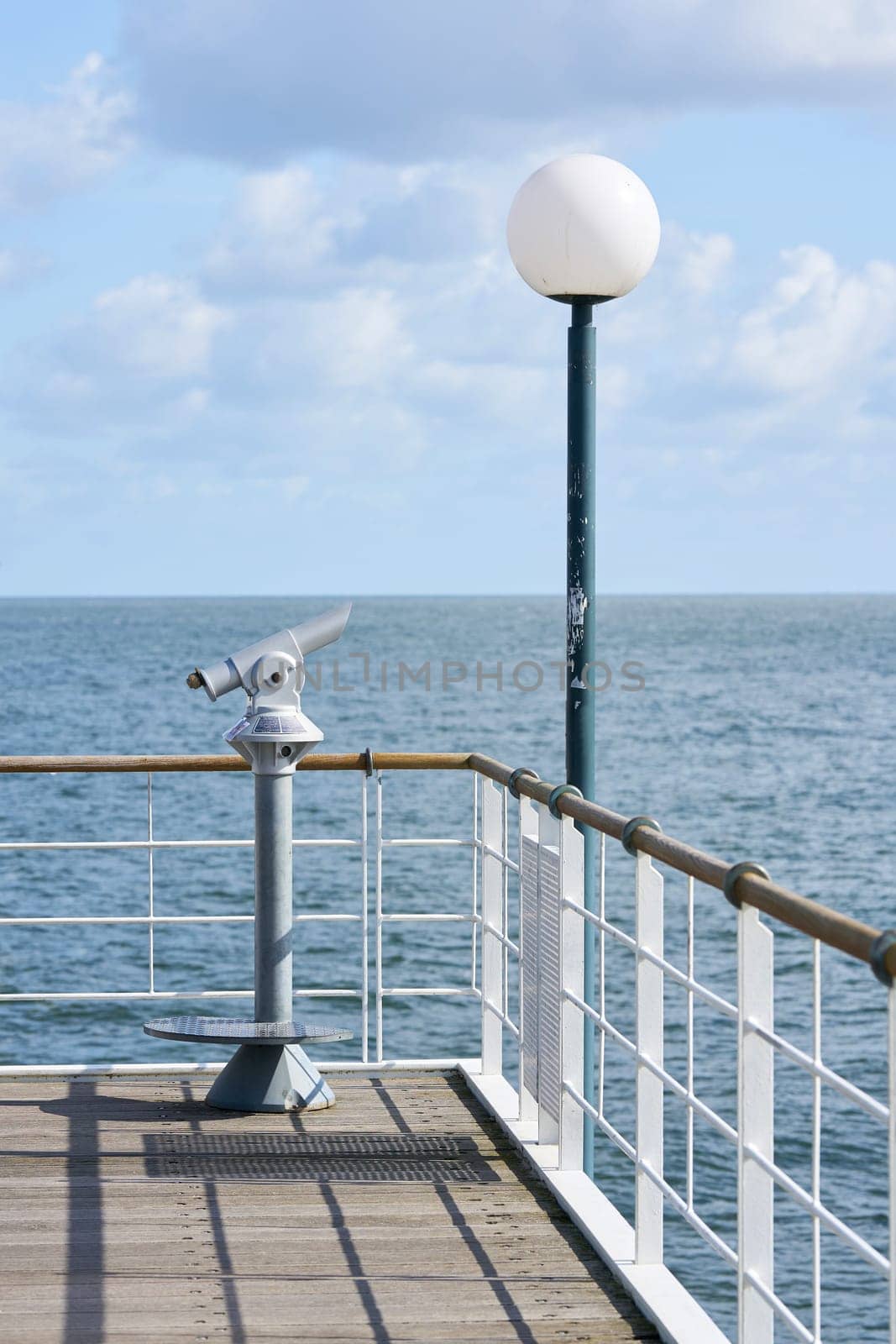 Lantern and telescope on the pier of Heringsdorf, the landmark of the town on the German Baltic coast