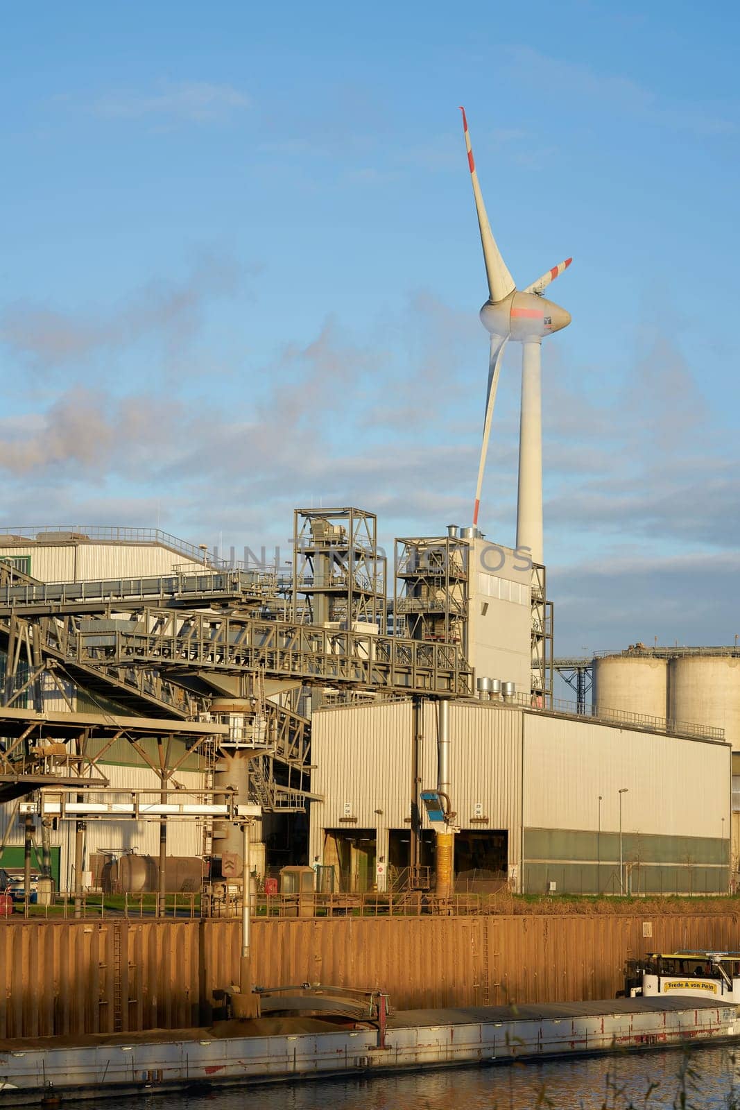 Industrial port in Magdeburg. In the background a wind turbine of the company Enercon.