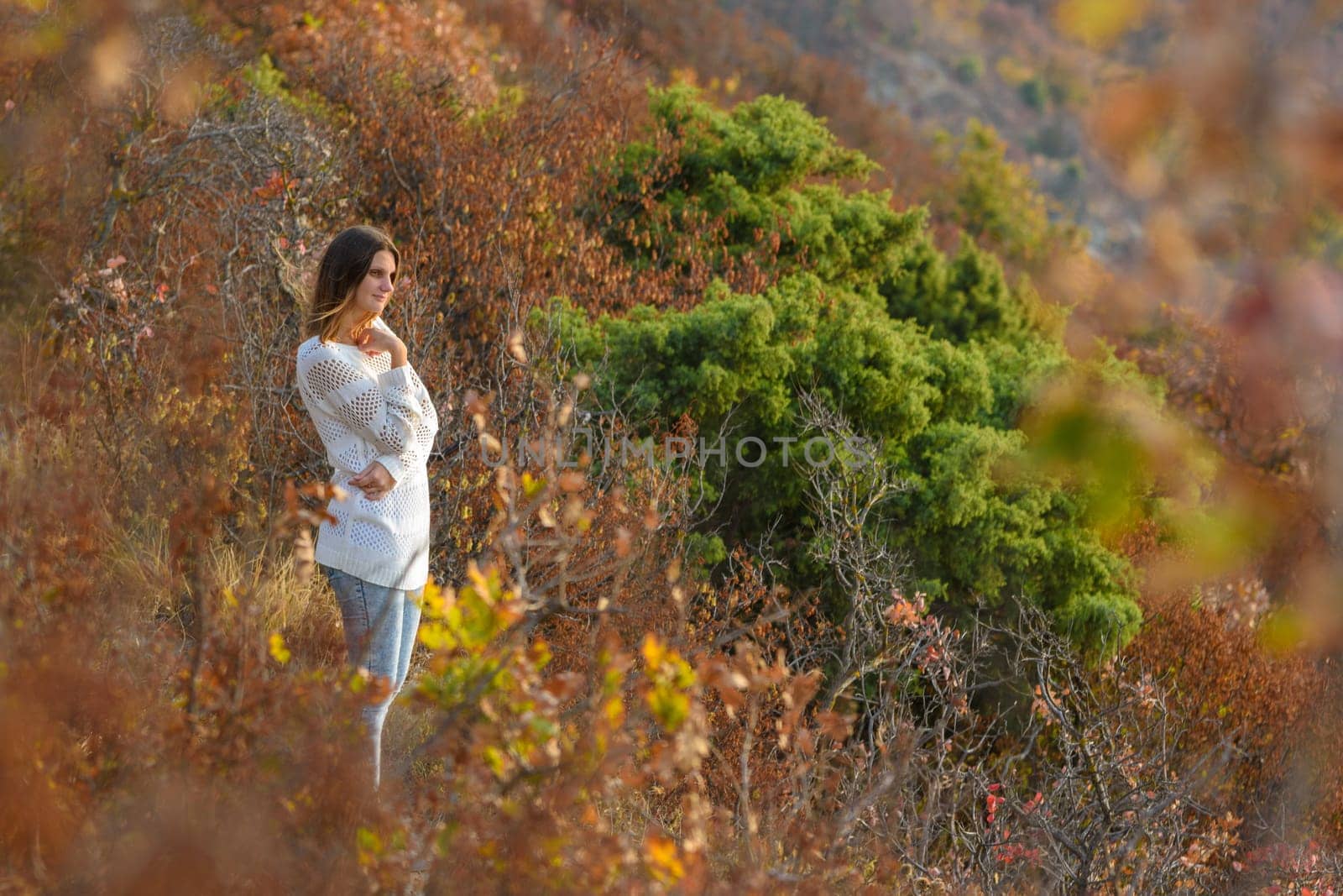 Girl walks in the forest on the mountainside