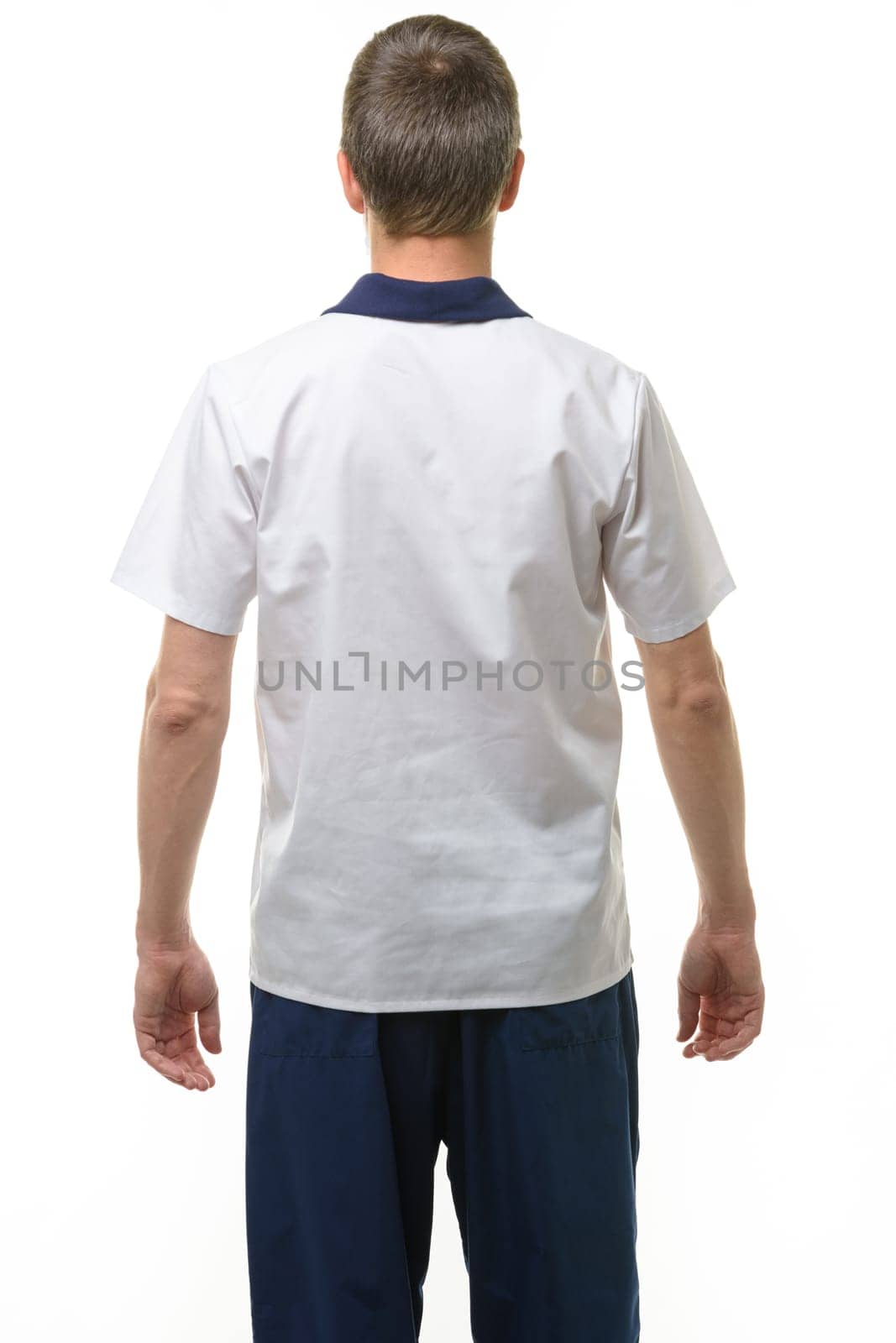 A man in a medical shirt and pants, a view from the back