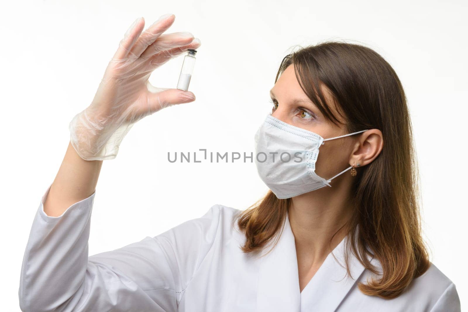 The doctor looks closely at the drug in the test tube