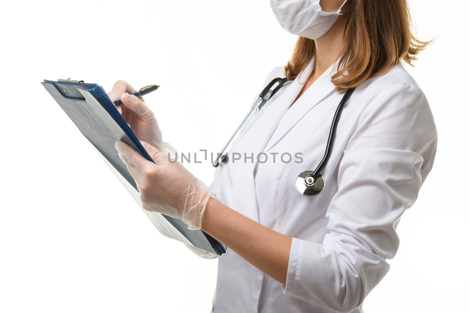 The doctor writes in a clipboard with a ballpoint pen