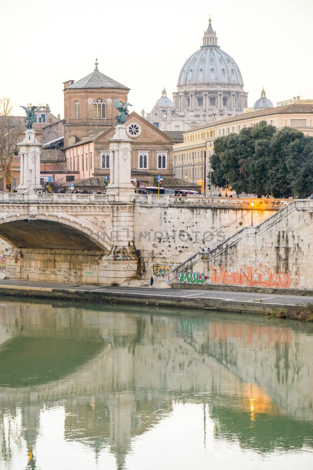 Rome, Italy - January 04, 2015:  bridge on tevere river in rome near vatican with people walking on bridge