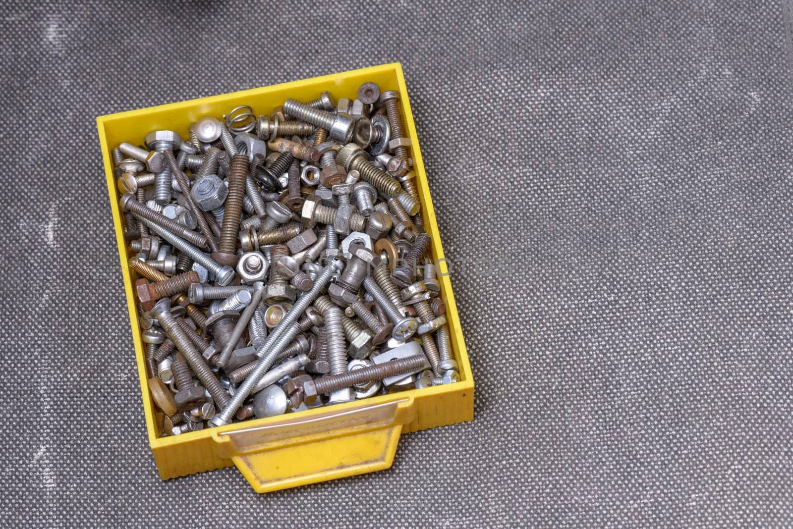 Yellow old box with several screws