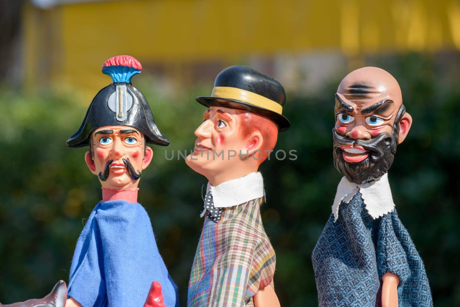 colorful puppets on a dark background, the devil, the policeman, the man