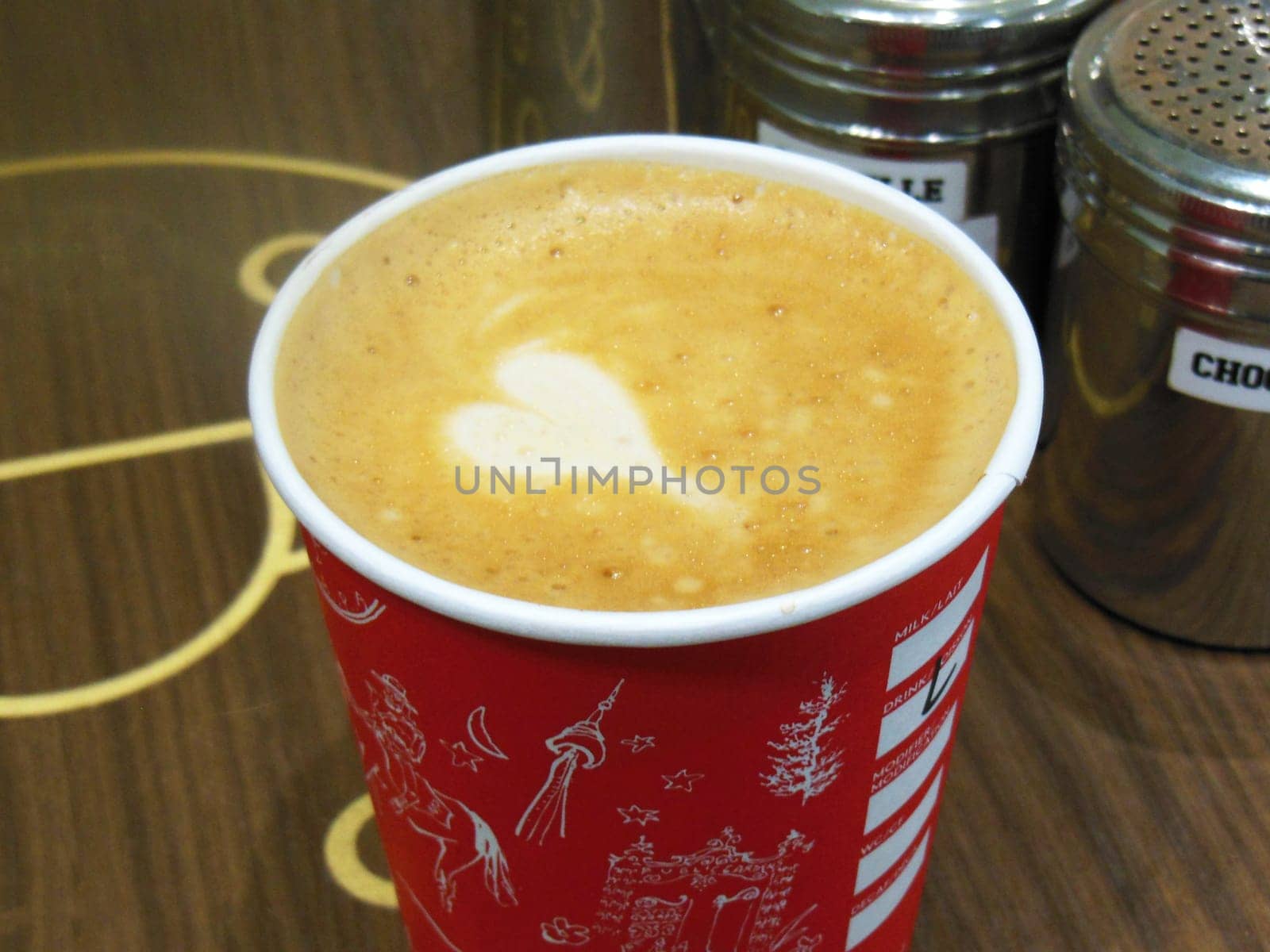 Cafe latte in cup with white foam heart shape