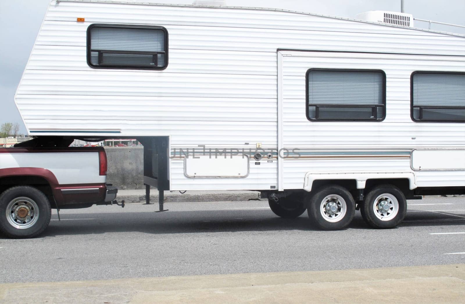 Pickup truck is towing a family camping trailer on a holiday trip