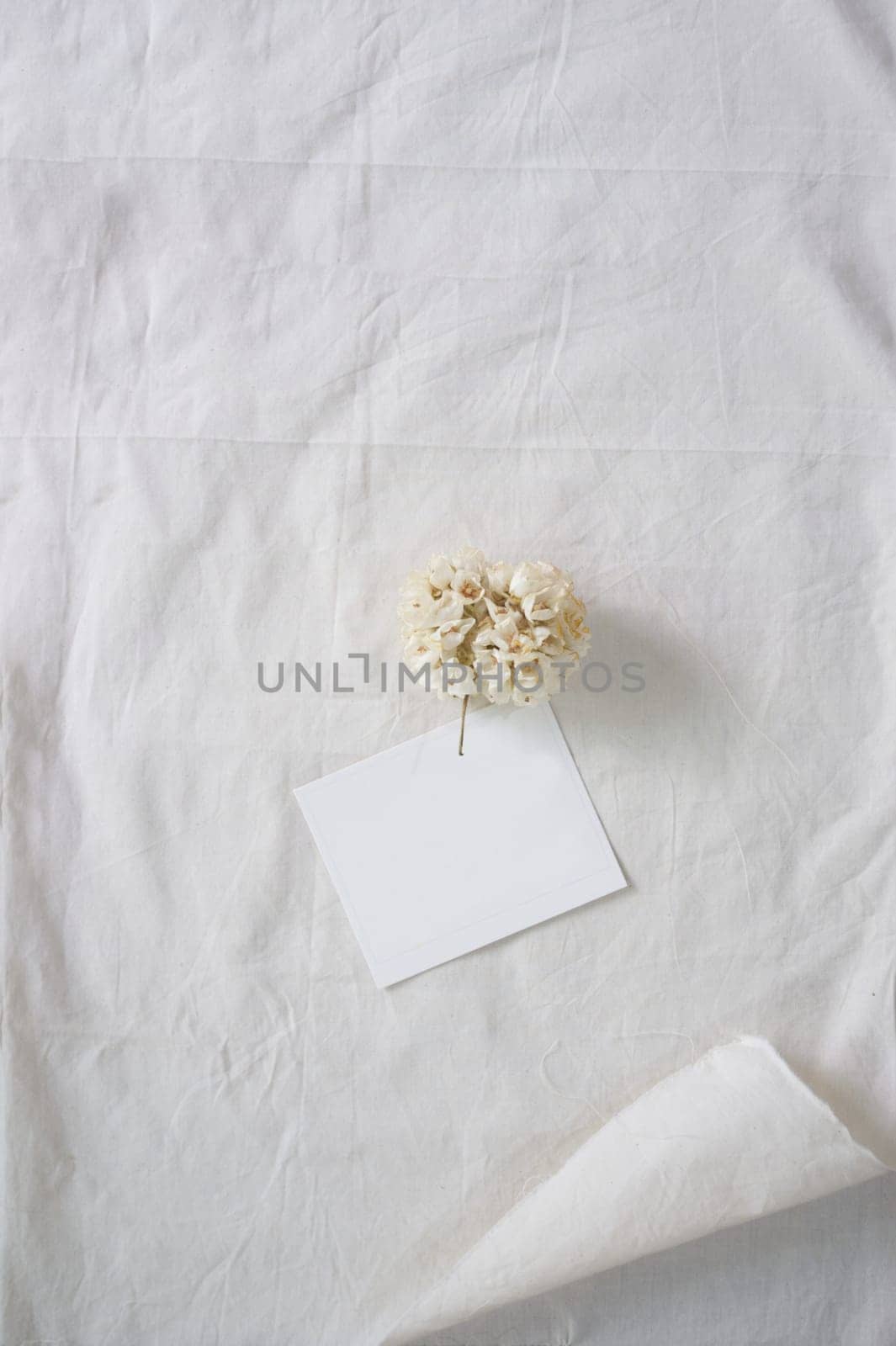 White paper and whit flower on white fabric , decoration background