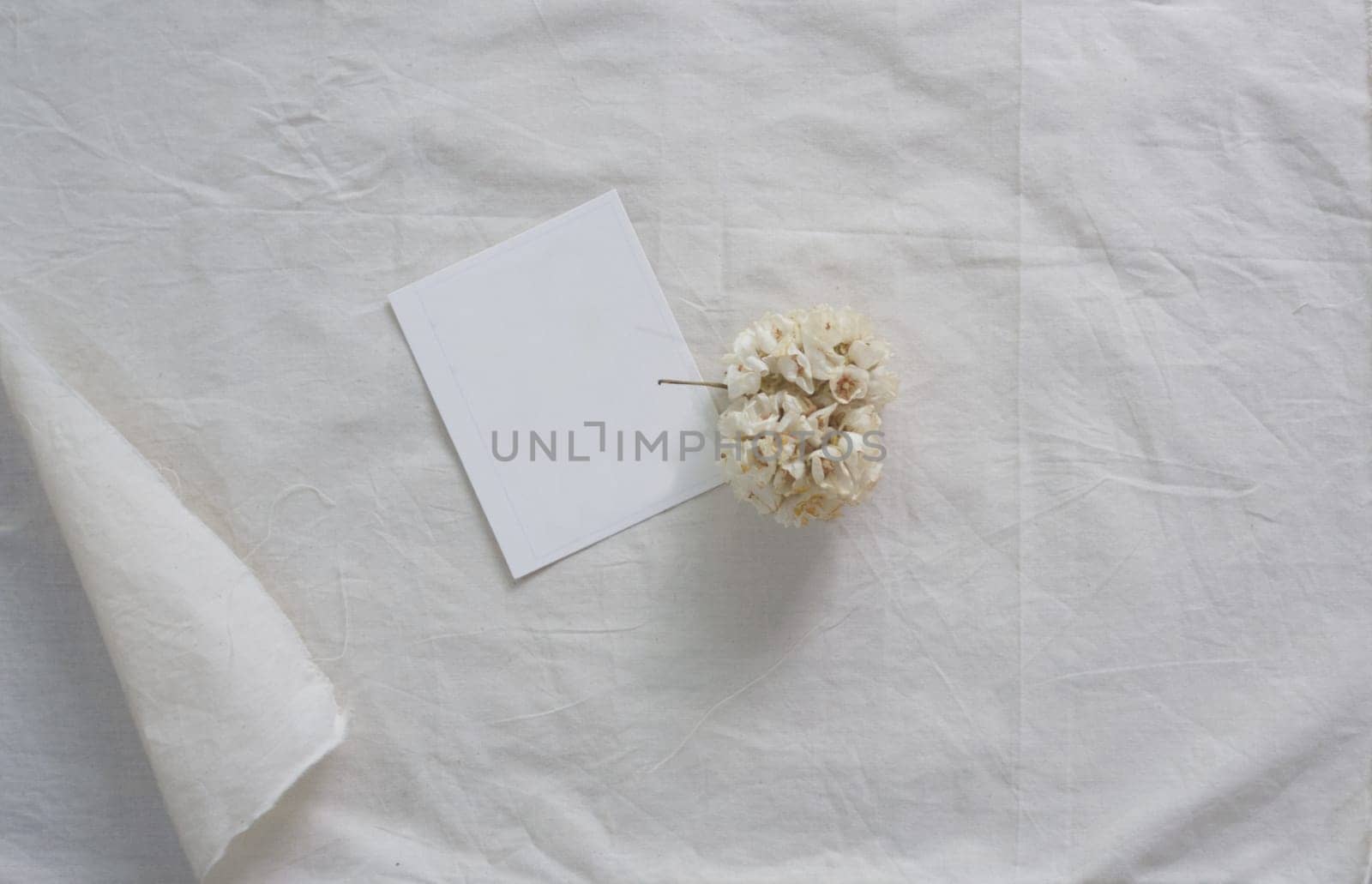 White paper and whit flower on white fabric , decoration background