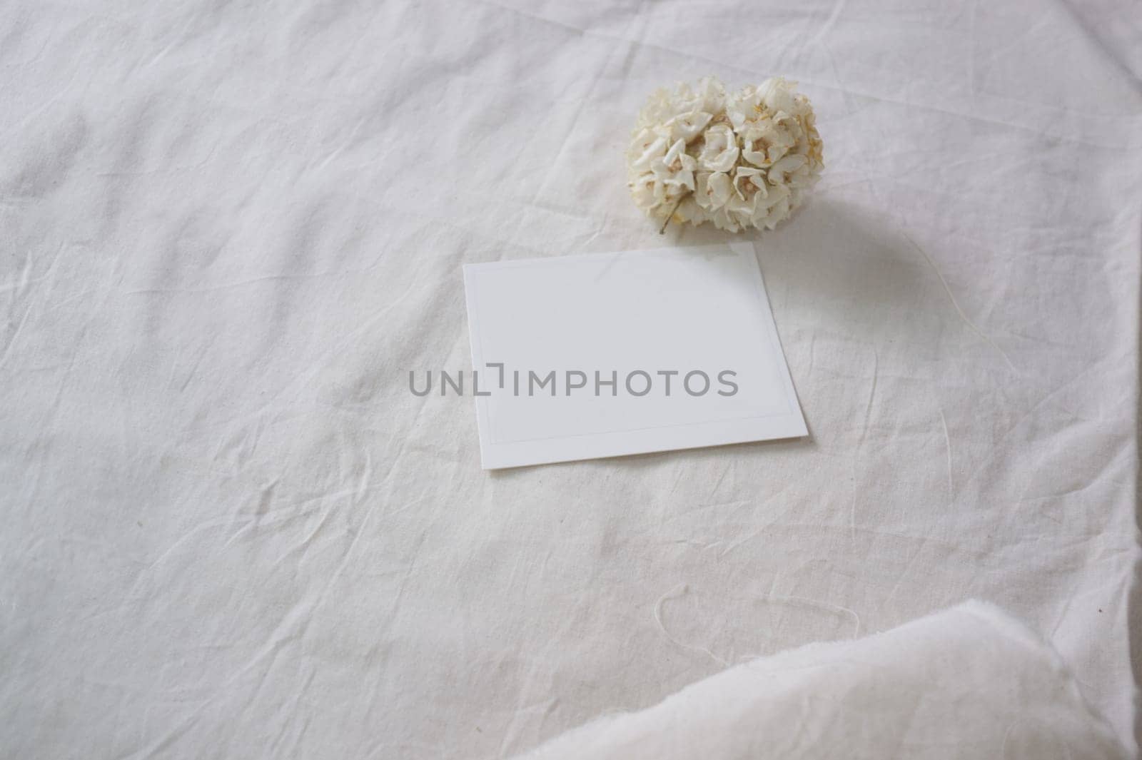 White paper and whit flower on white fabric , decoration background