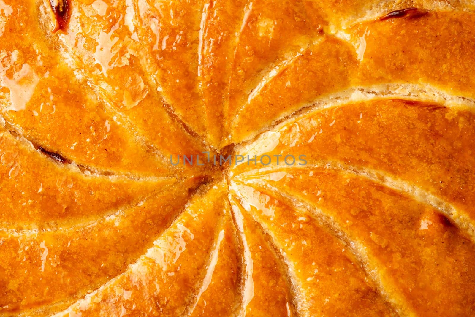 Detail shot of Epiphany cake or galette des rois in French shows the shiny texture of the puff pastry