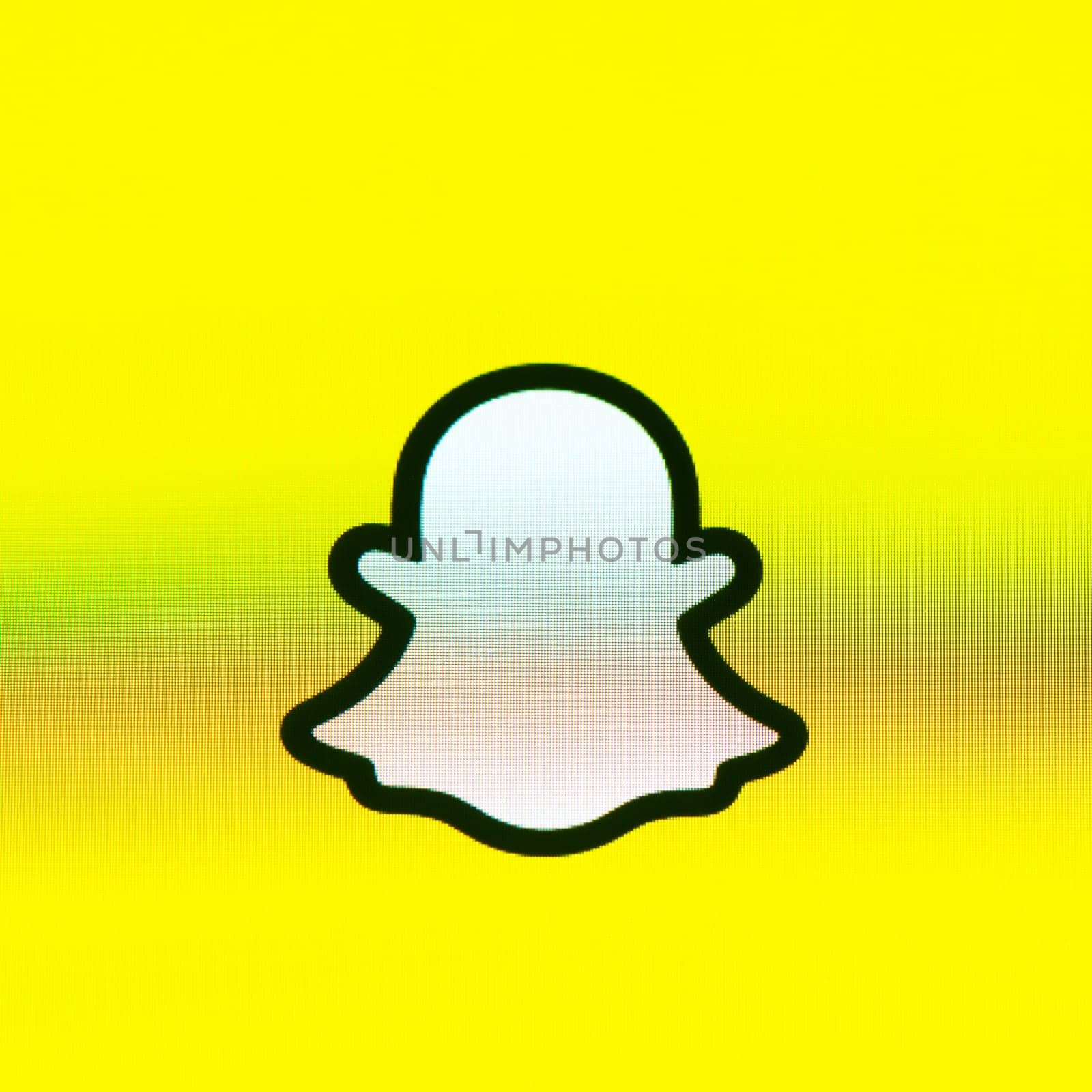 BAYONNE, FRANCE - CIRCA JANUARY 2021: Snapchat ghost logo on yellow background, Apple iPhone screen. Snapchat is a multimedia messaging app developed by Snap Inc.