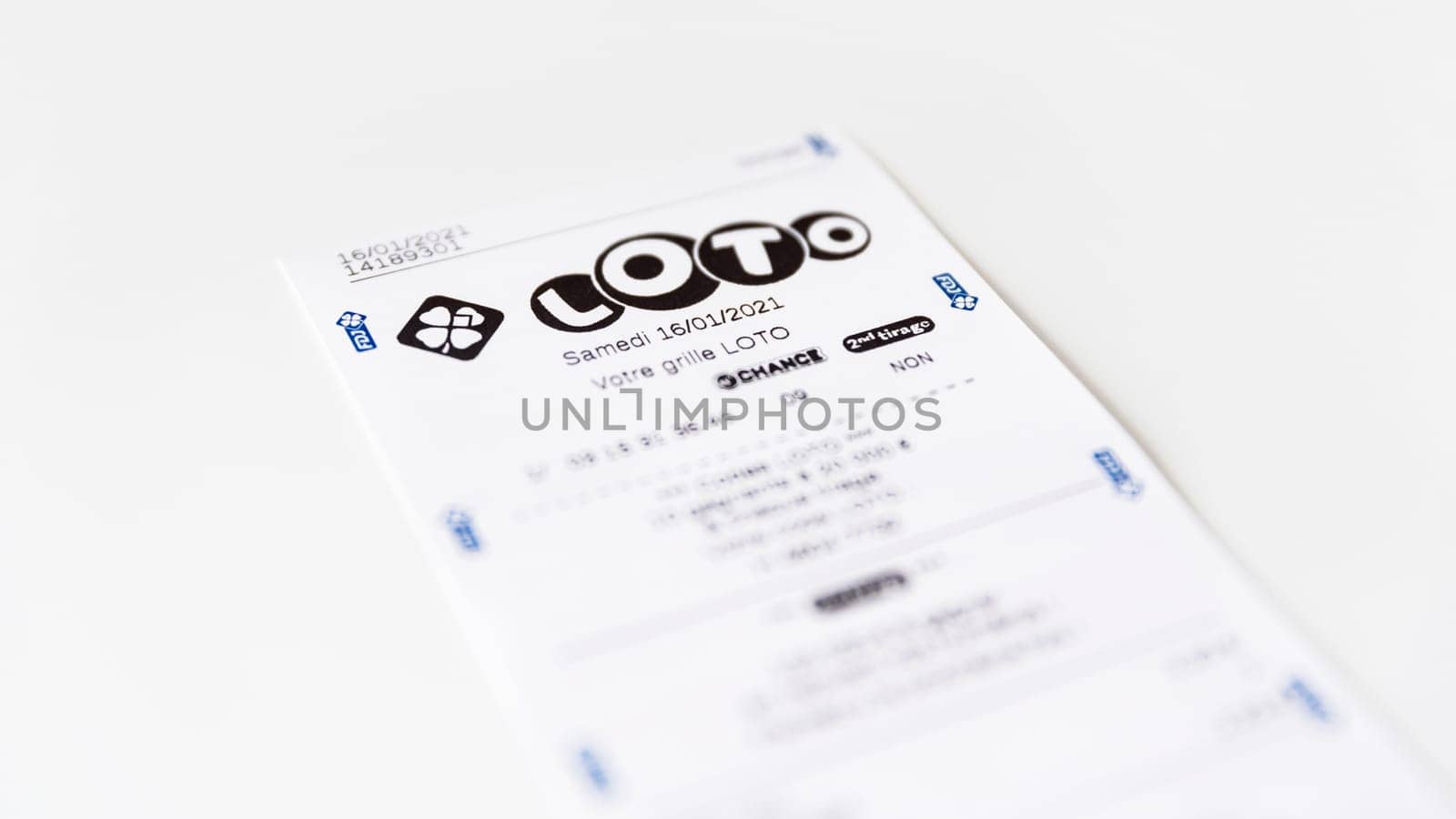 BAYONNE, FRANCE - CIRCA JANUARY 2021: Francaise des Jeux Loto receipt on white background. Loto is one of the games of Francaise des Jeux, France's national lottery operator.