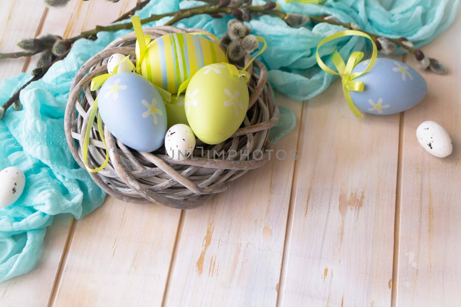 Easter decoration with eggs in nest in green and blue color