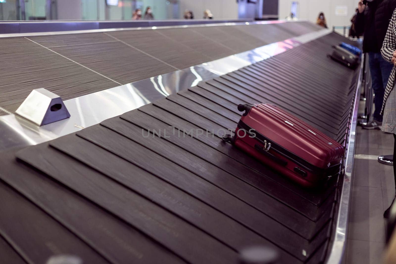 Suitcase on luggage conveyor in the baggage claim area at the airport. Lockdown
