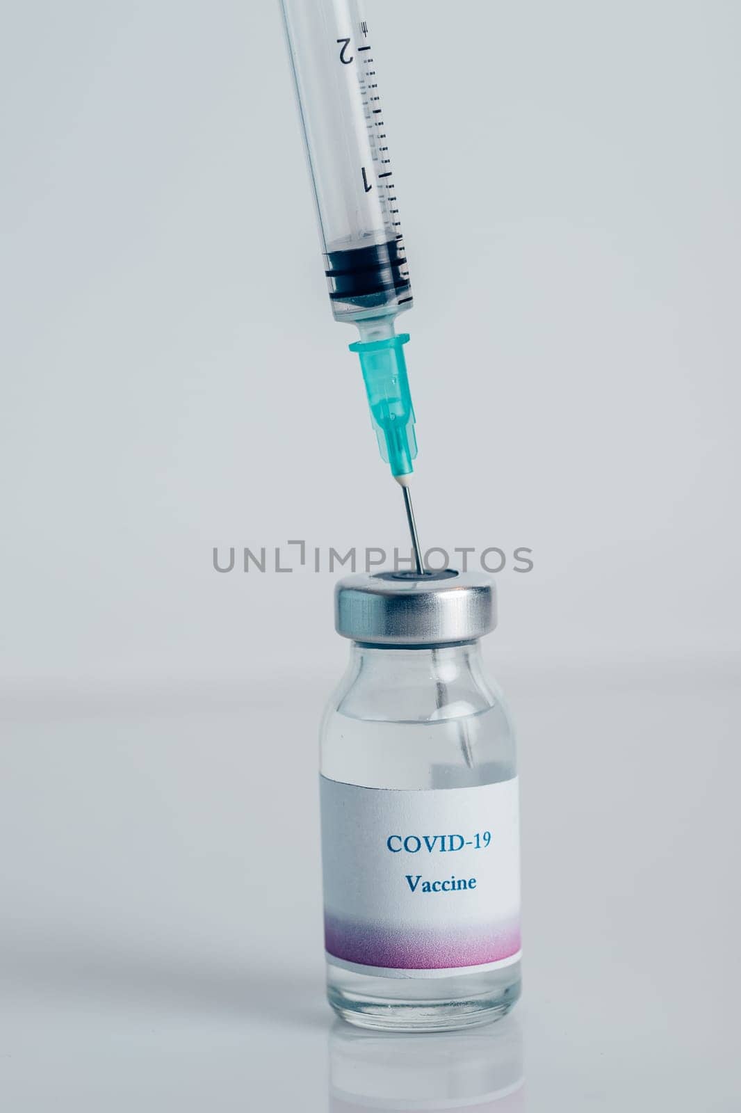 Close-up of a vial with vaccine against COVID-19 and syringe. Bottle with coronavirus vaccine developed for protection against COVID-19. Concept of immunization and biotechnological development.