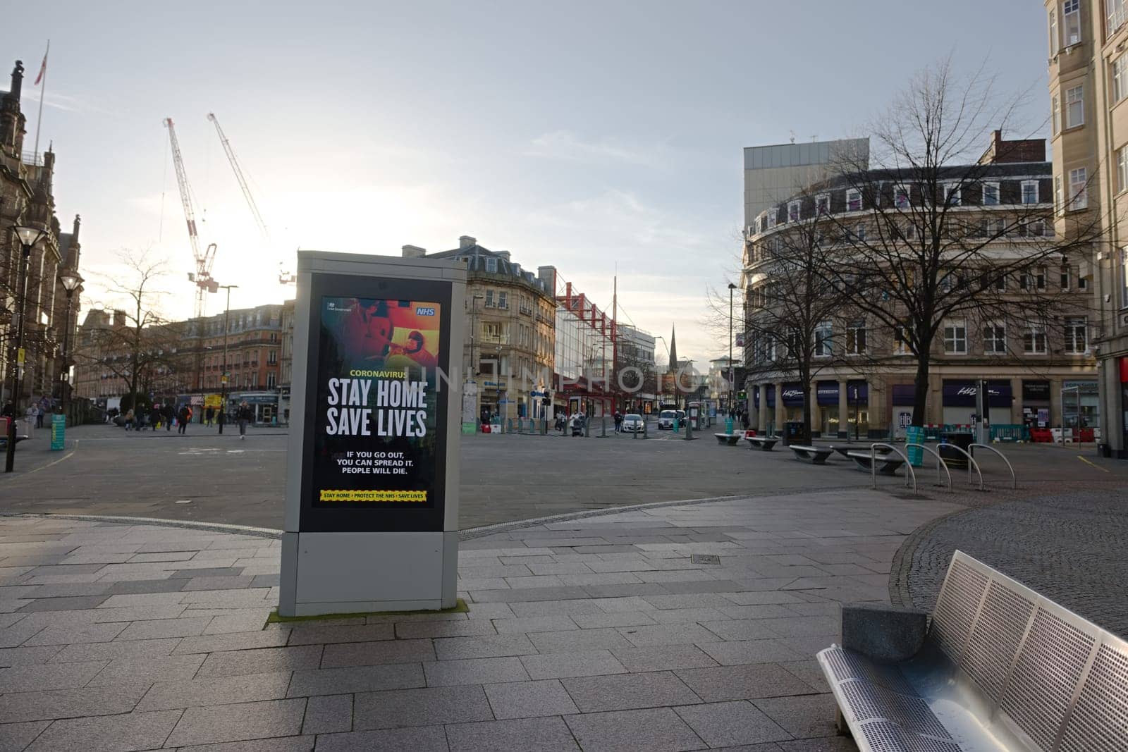 Sheffield, United Kingdom, 12th January, 2021: Stay at home government COVID-19 guidance slogan displayed next to an empty bench. Fargate in sheffield