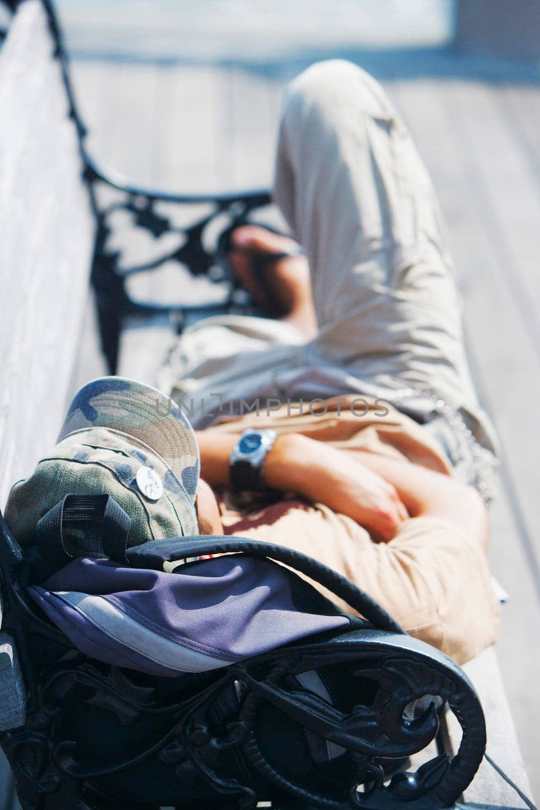 High angle view of a man lying on a bench