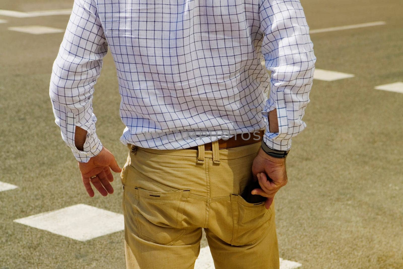 Rear view of a man taking out a wallet from his pocket