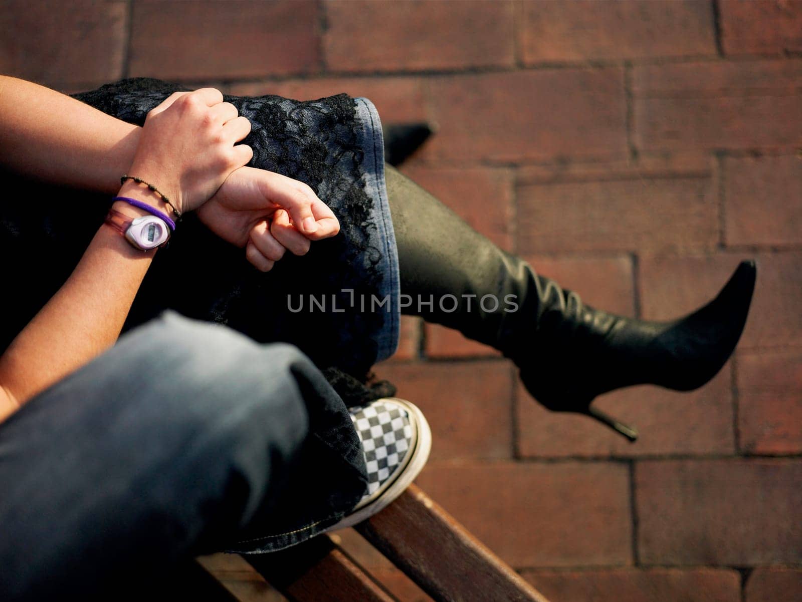 Low section view of a couple sitting on a bench