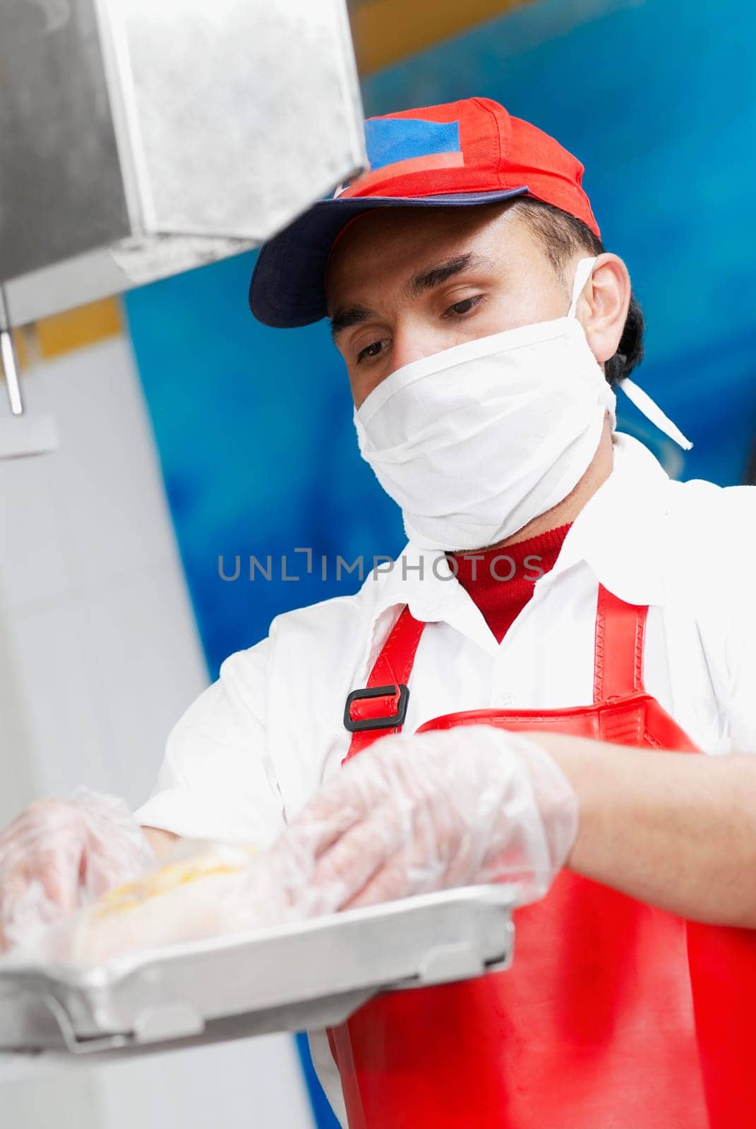Close-up of a butcher weighing meat in a butcher shop