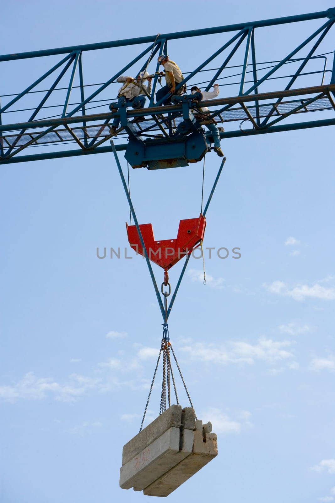 Low angle view of three construction workers working at a construction site