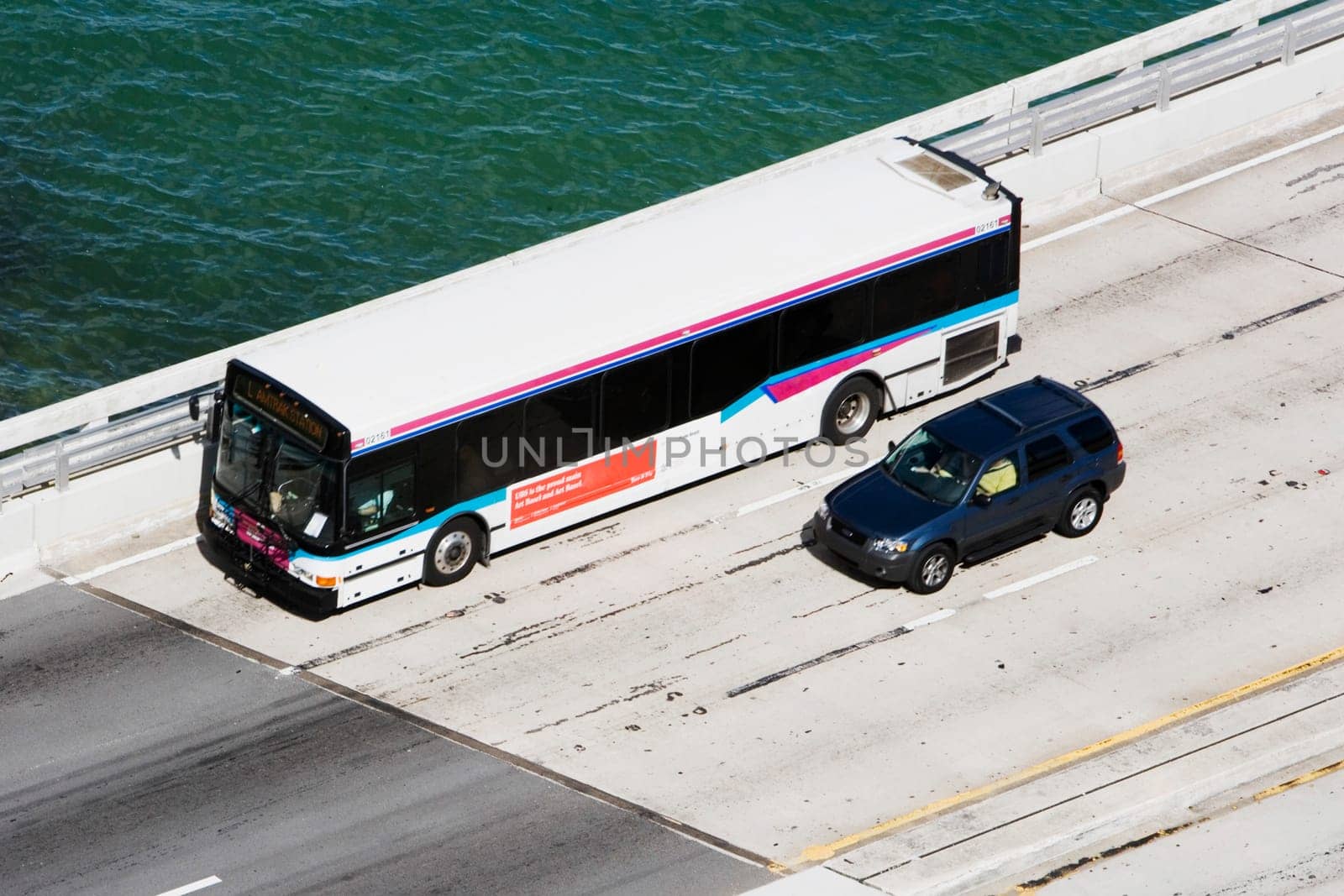 High angle view of a bus and a car moving on a bridge