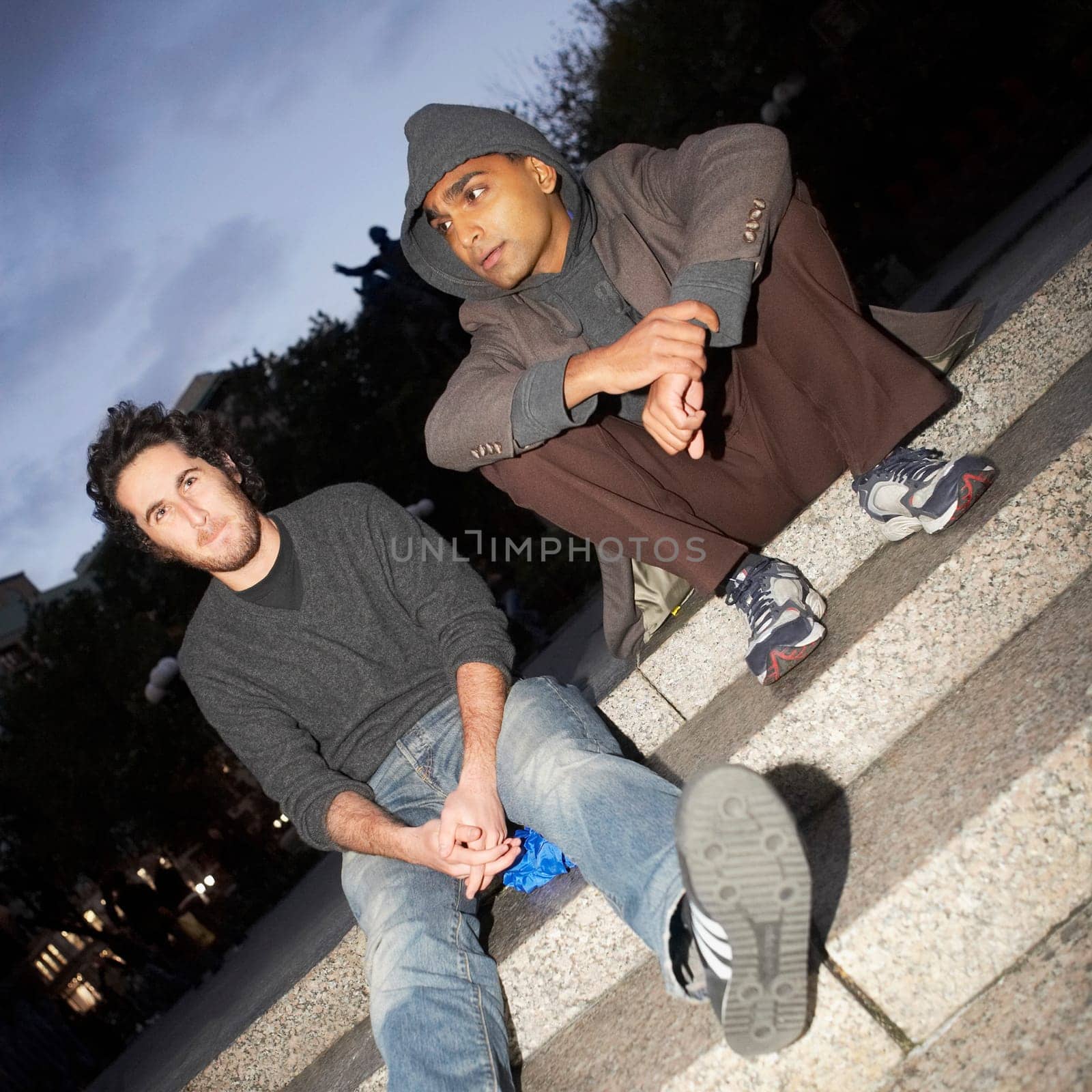 Two young men sitting on steps