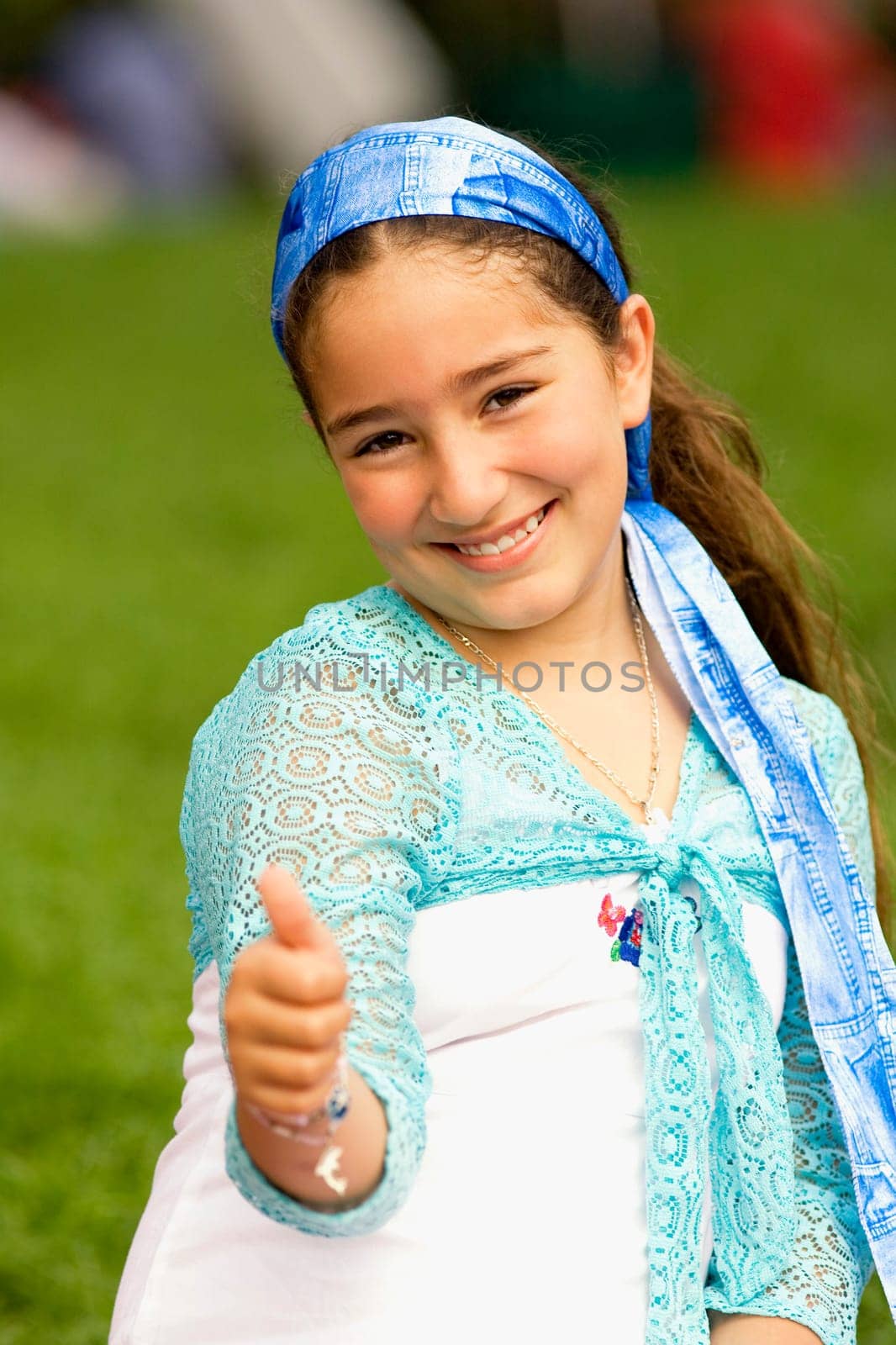 Portrait of a girl showing a thumbs up sign