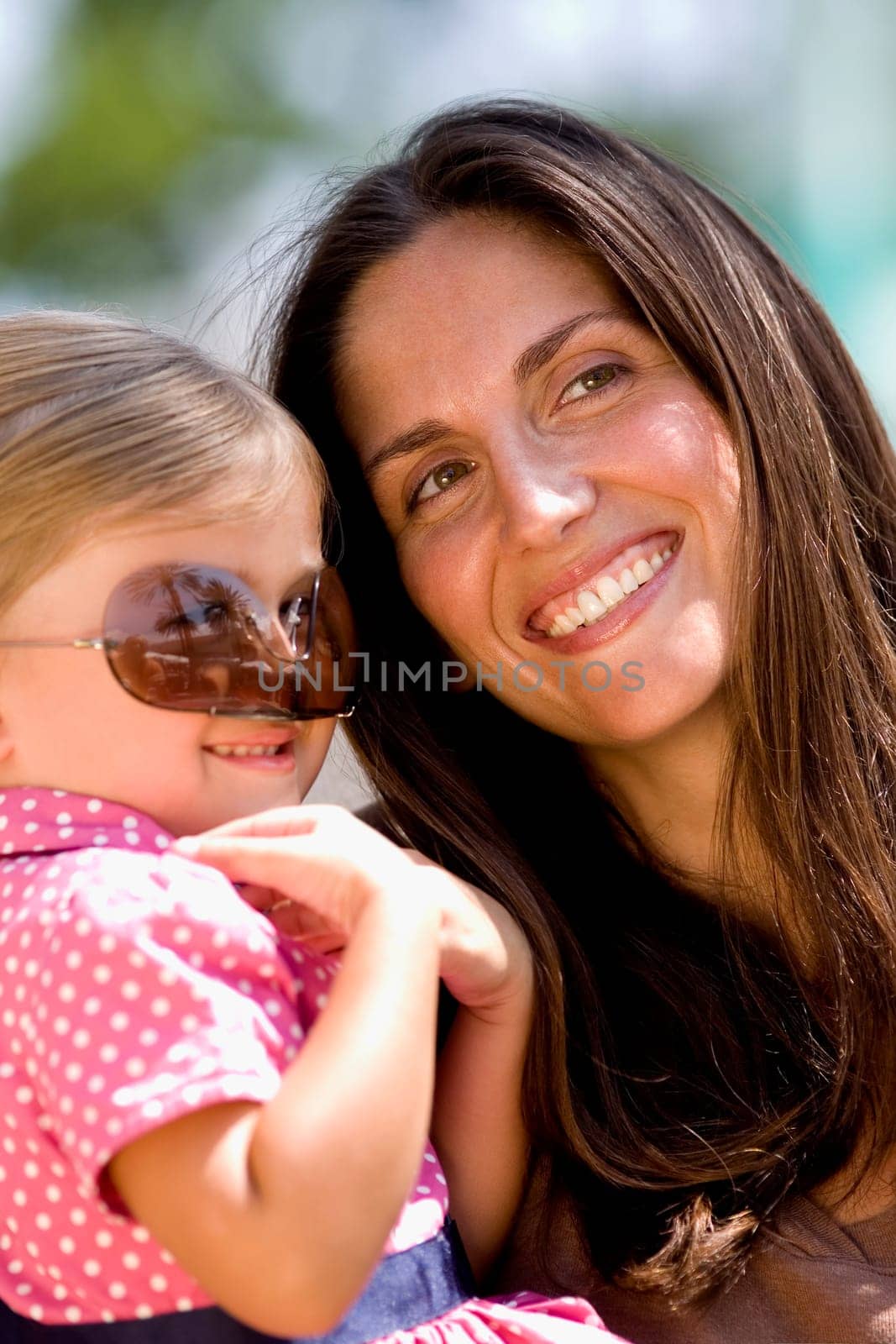Close-up of a mid adult woman smiling with her daughter