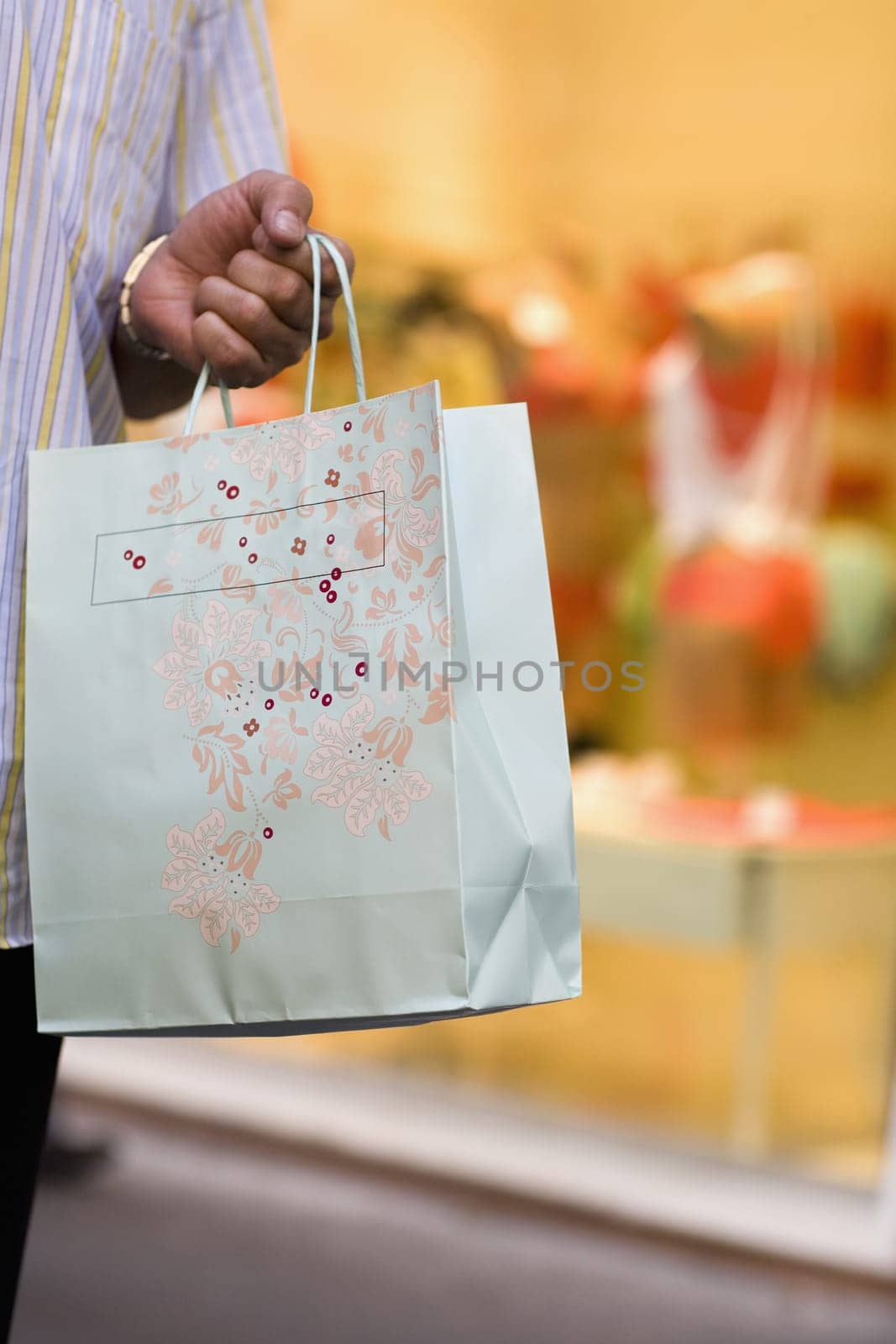 Close-up of a man carrying a shopping bag
