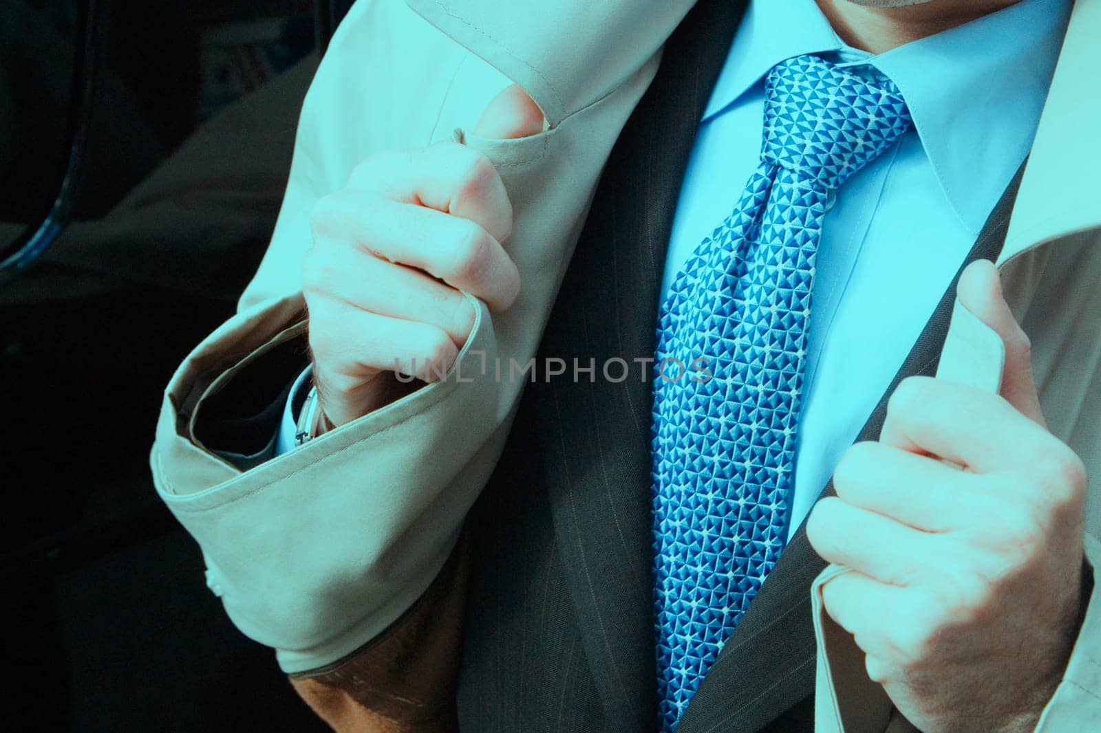 Mid section view of a businessman wearing an overcoat