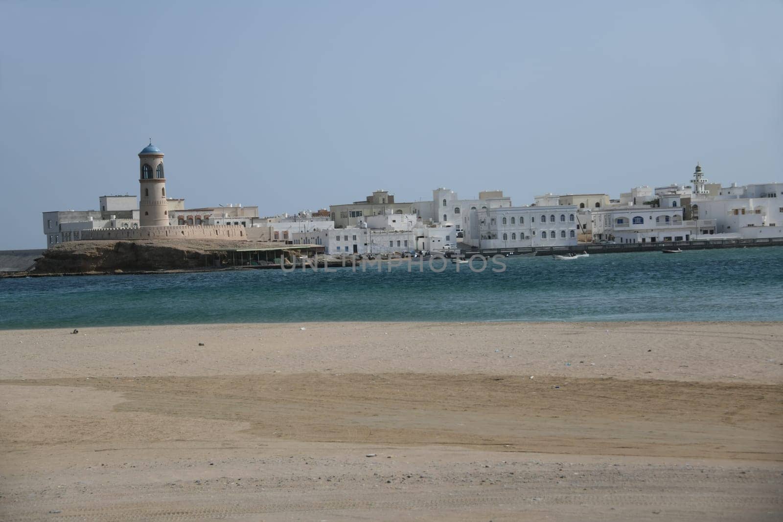 The lighthouse in the small town of Al Ayjah in Oman is located on the Gulf of Oman and opposite the port city of Sur with its famous dhow shipyard.