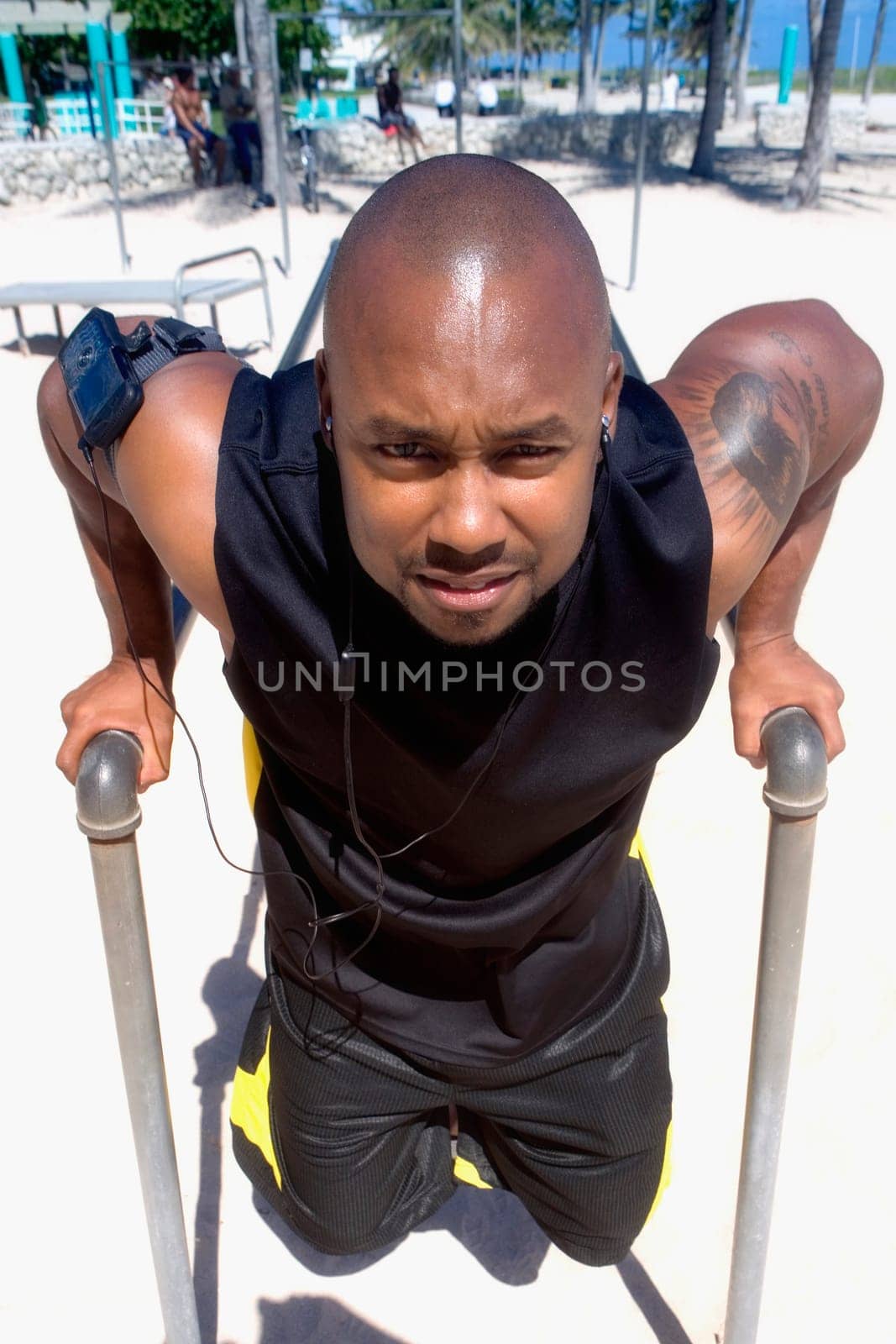 Portrait of a mid adult man exercising on parallel beams