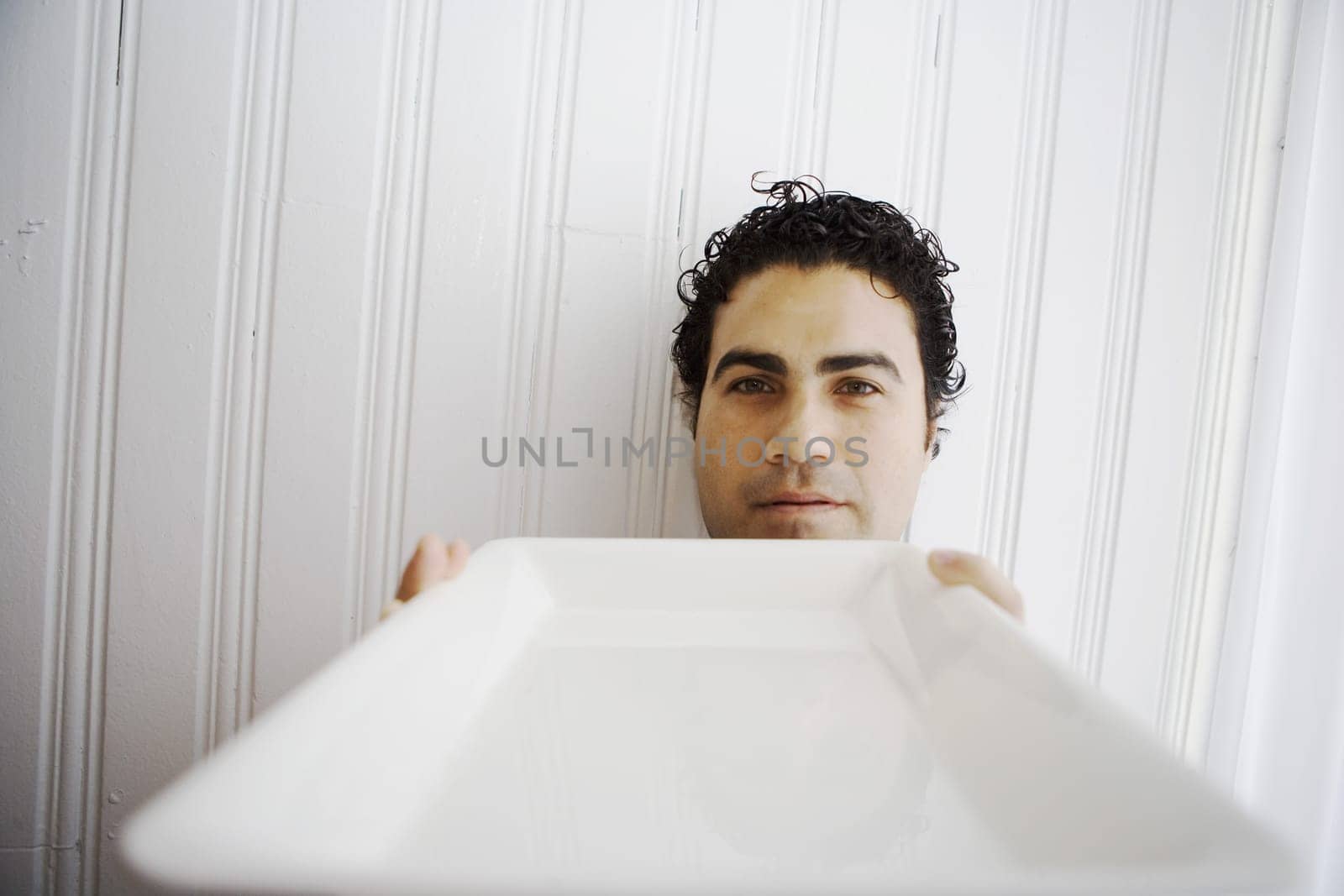 Portrait of a waiter holding a tray