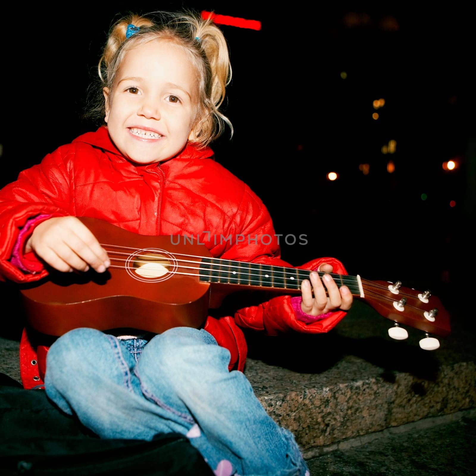 Portrait of a girl playing the guitar
