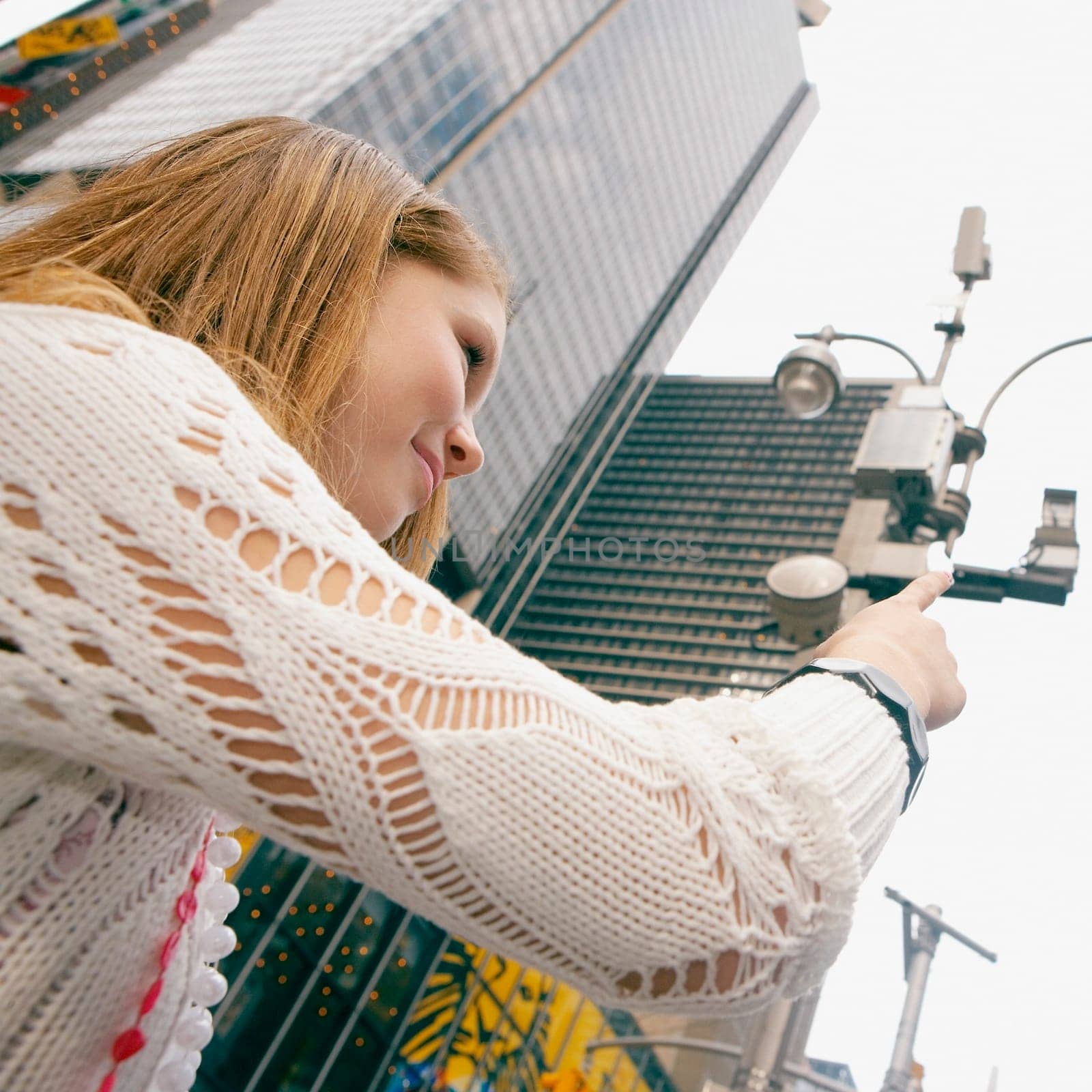 Low angle view of a teenage girl pointing up
