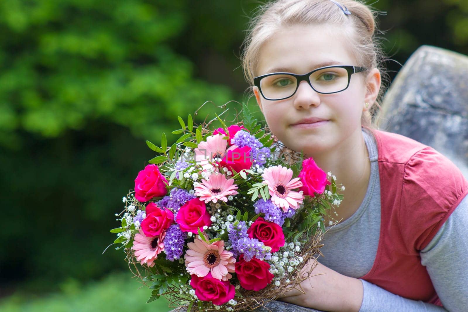 cute young girl with flowers - gift for the mother