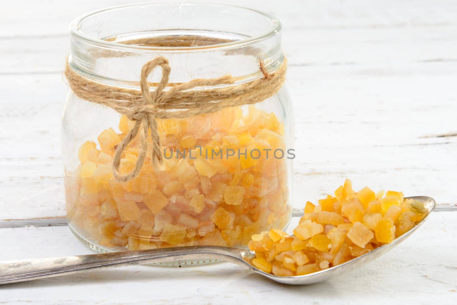 candied oranges cut into pieces on the white wooden table