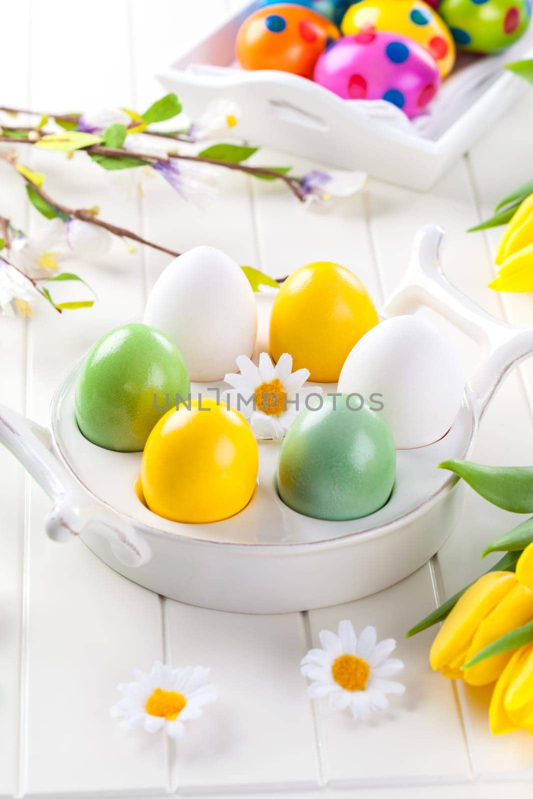 Easter eggs with spring flowers decorating table