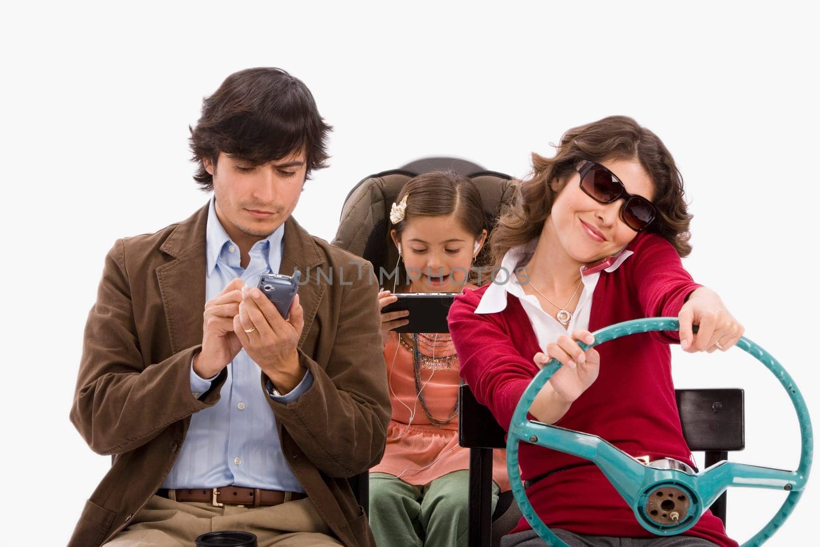 Studio portrait of distracted family in imaginary car